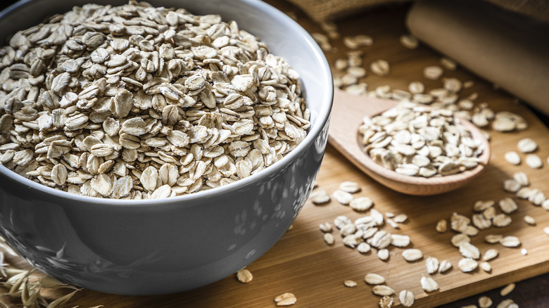 oats in gray bowl and wooden spoon