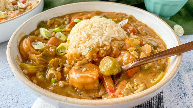 Bowl of gumbo topped with rice