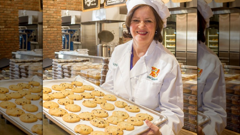 Woman carrying fresh cookies on a tray 