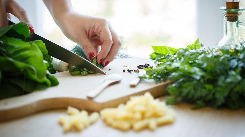 Women chopping fresh herbs