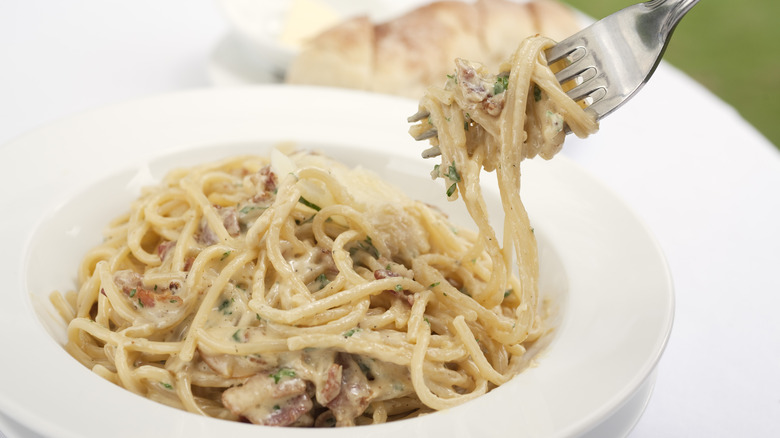 Spaghetti carbonara on fork