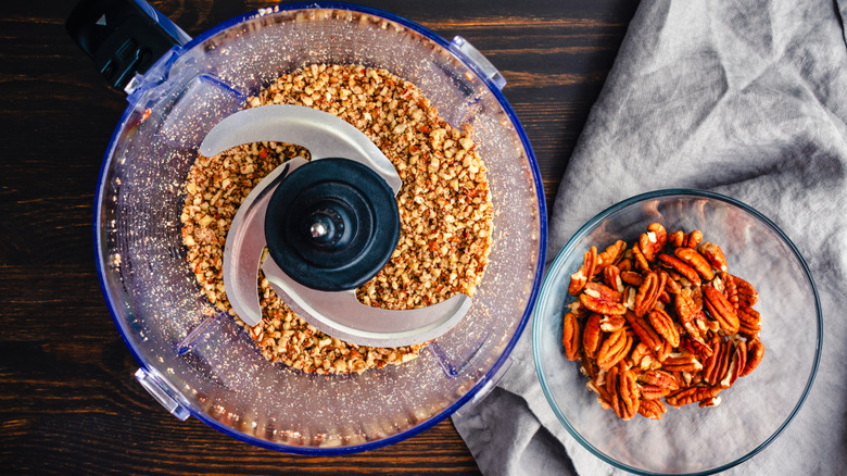 Overhead of ground nuts in food processor.