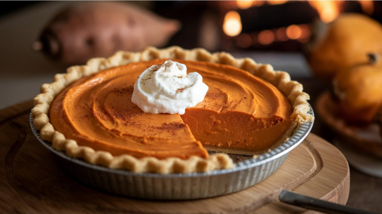 Sweet potato pie with slice missing.