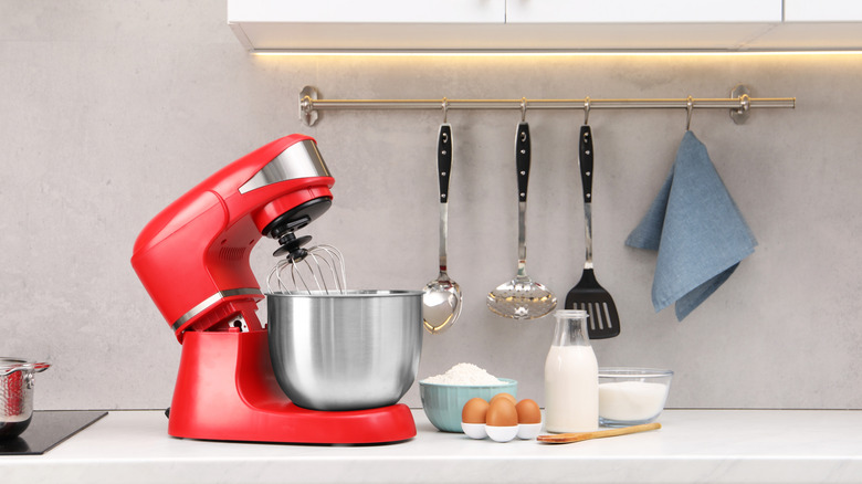 Red stand mixer on a counter.