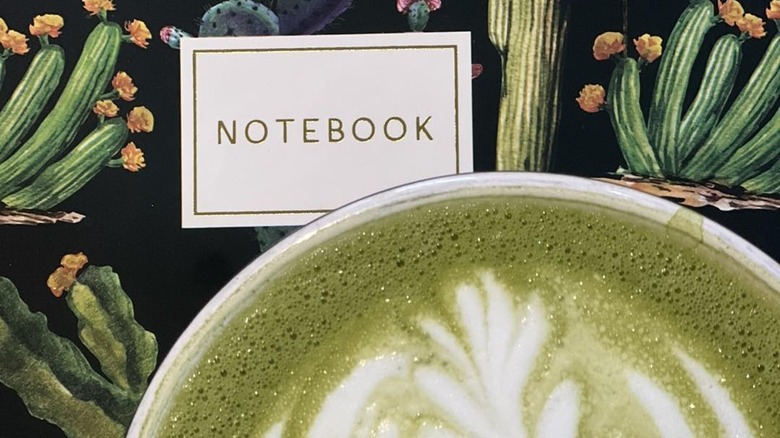 Matcha latte and a notebook