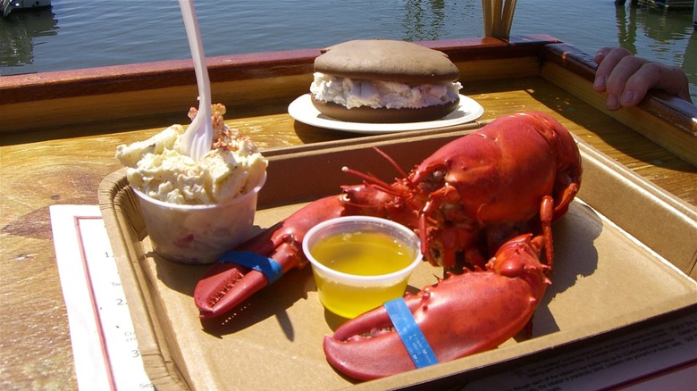 Cooked lobster served with a potato salad and a whoopie pie