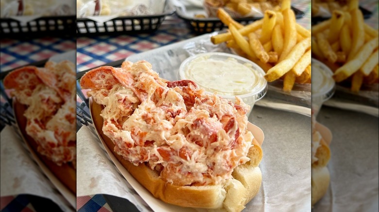 Close-up of a lobster roll with mayo and fries on the side