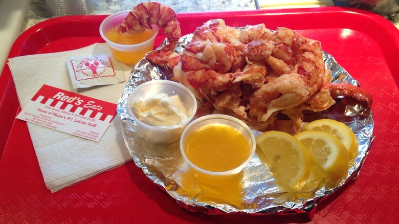 Lobster meat served with butter, mayonnaise and lemon slices on the side