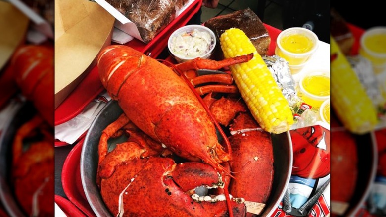 Steamed lobster served with corn and butter on the side