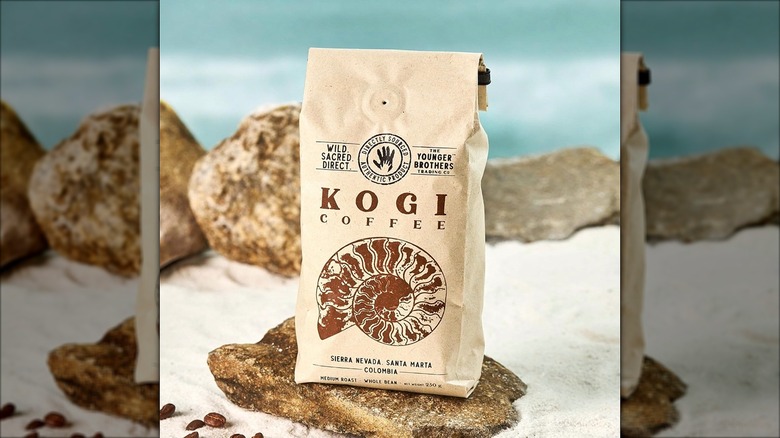 Bag of Kogi Coffee from Younger Brothers Trading Co on rock in sand