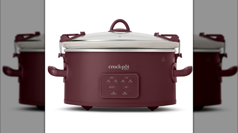 burgundy-colored Crock-Pot with digital interface and white ceramic insert on white background