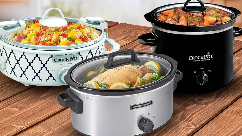 three different slow cookers filled with food on wooden table