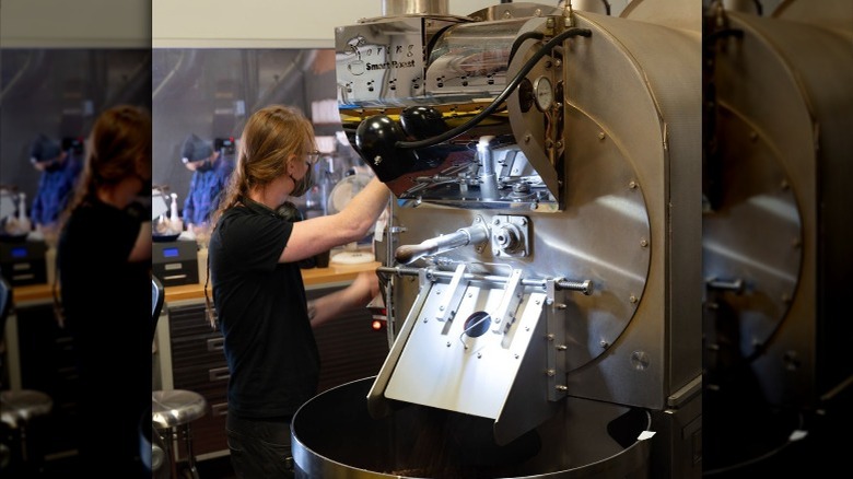 Person operating coffee roasting machine