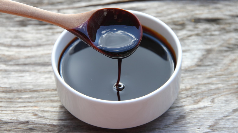 Bowl of molasses dripping from spoon