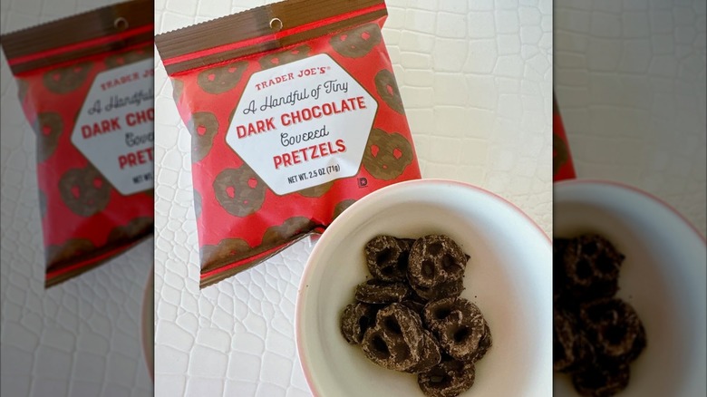 Bowl of chocolate covered mini pretzels next to small bag