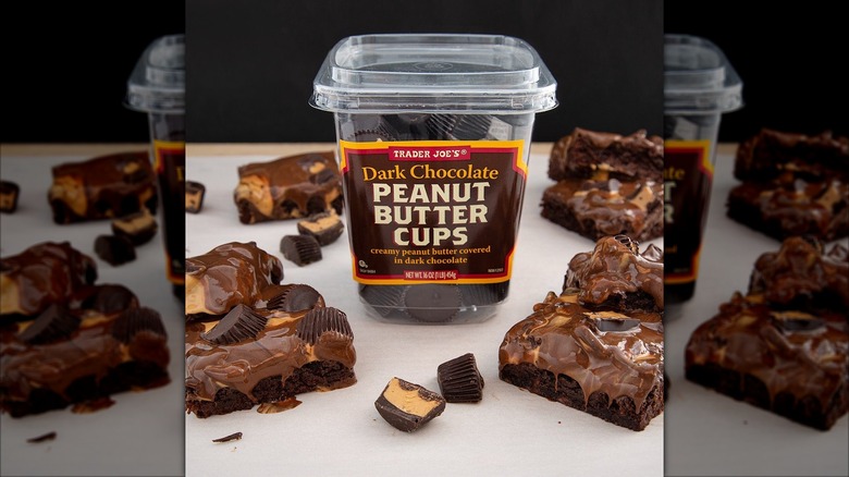 Box of dark chocolate peanut butter cups surrounded by peanut butter cup brownies