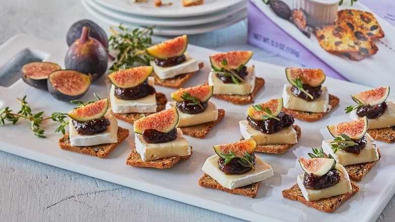 Trader Joe's Fig and Olive Crisps with cheese, jam, and real fig slices on top