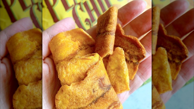 Hand holding plantain chips