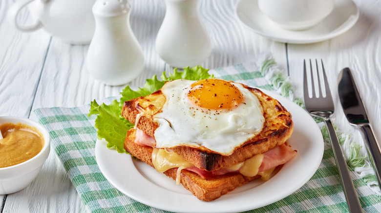 Croque-madame on white plate