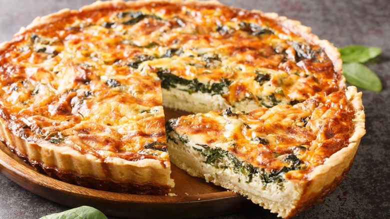 Spinach quiche on wooden board