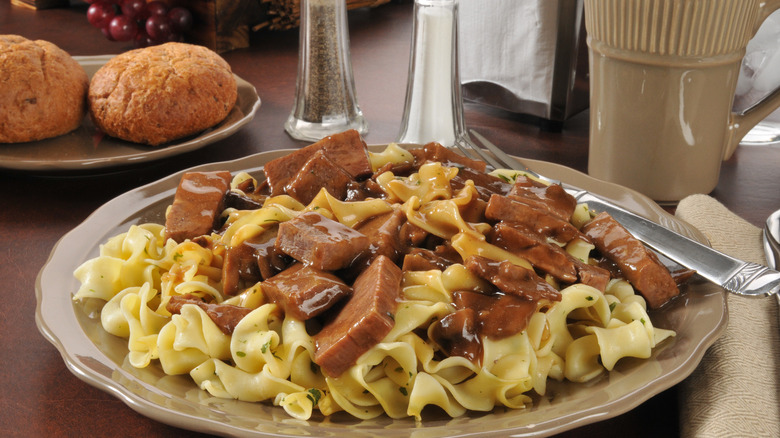 beef tips and noodles on a plate