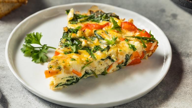 Slice of frittata on white plate