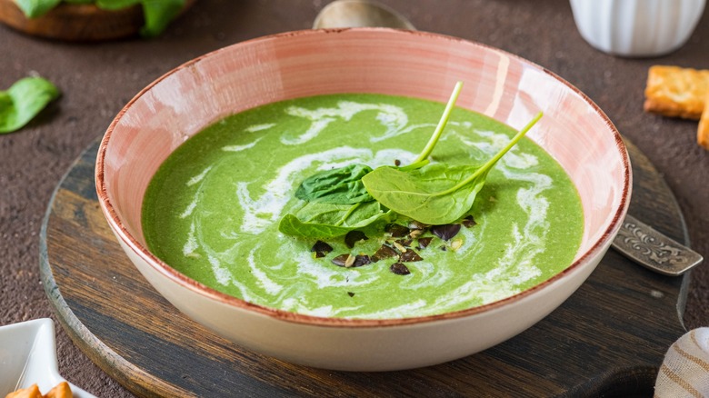 Green soup in pink bowl 