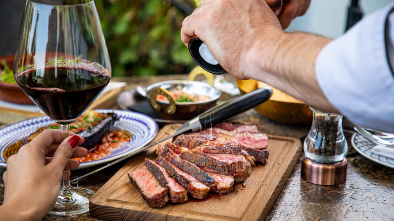 red wine glass sliced steak