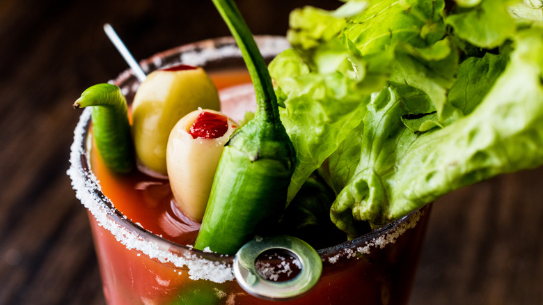 Olives, peppers, and lettuce in bloody mary