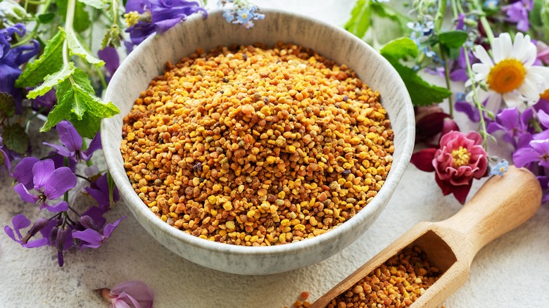 Bee pollen in bowl, flowers