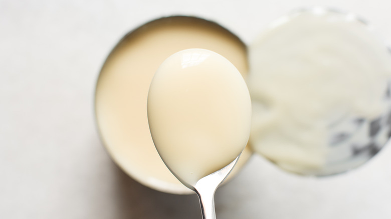 Spooning condensed milk from can