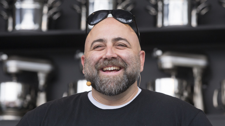 Duff Goldman smiling with sunglasses perched on head