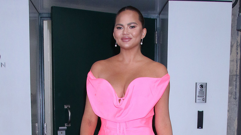 Chrissy Teigen in a pink dress