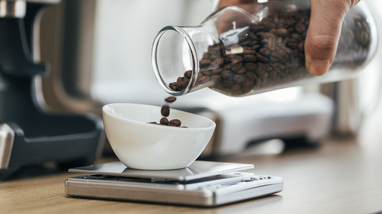 pouring coffee beans on scale