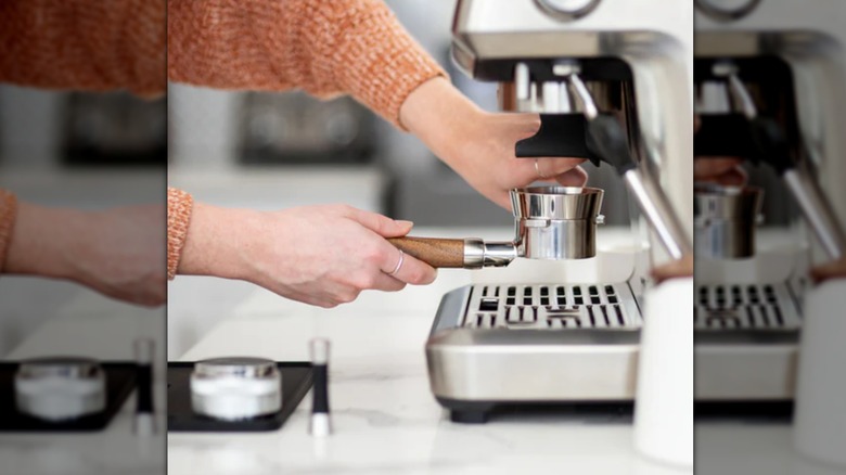 woman using portafilter with funnel