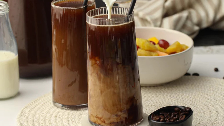 Bold Cold Brew Coffee in glasses with fruit in background