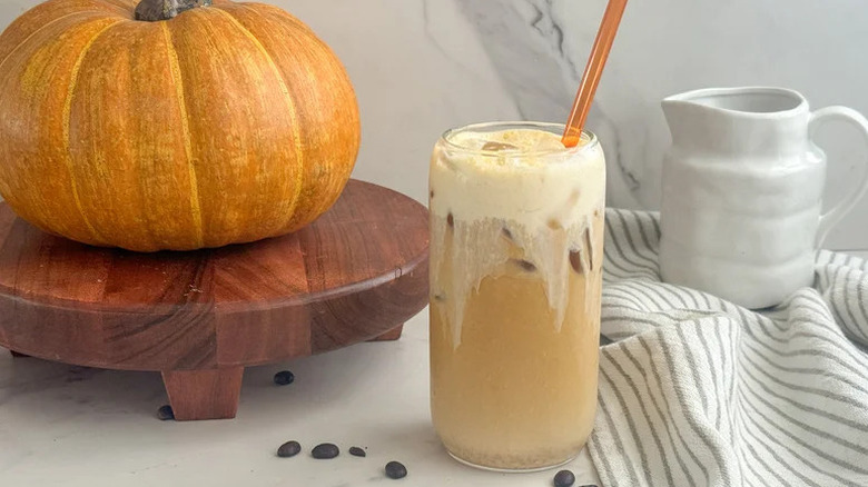 DIY Starbucks pumpkin cream cold brew on white countertop with pumpkin