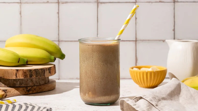 Frozen funky monkey banana mocha in glass on white countertop