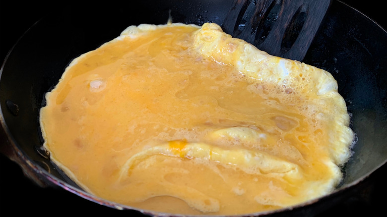 undercooked omelet in a pan