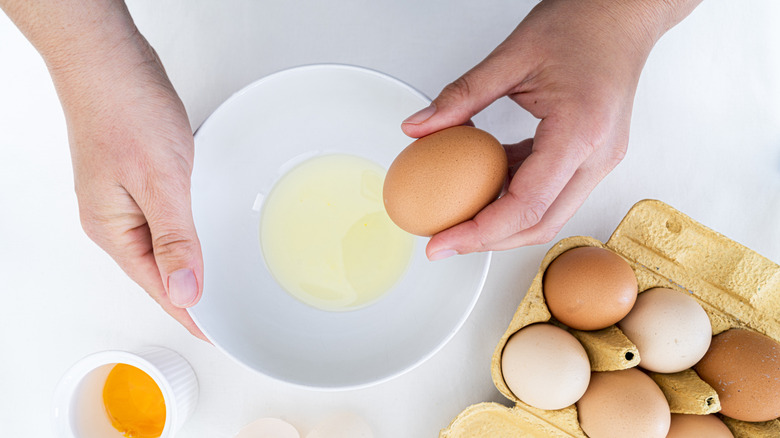 hands preparing eggs