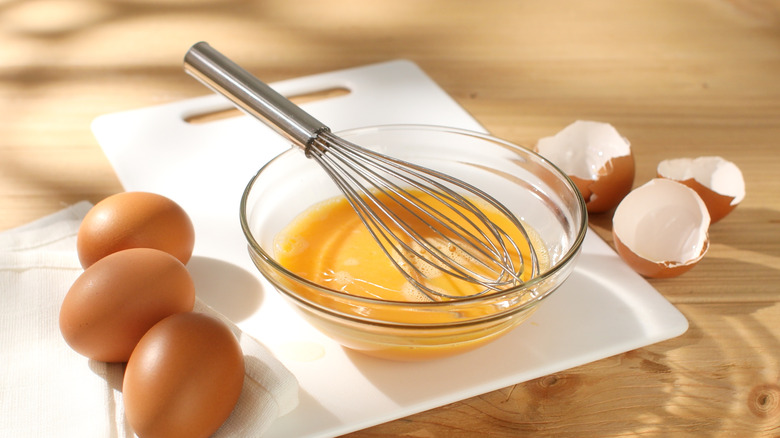 whisk in bowl of eggs