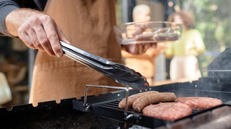 Man grilling in canvas apron