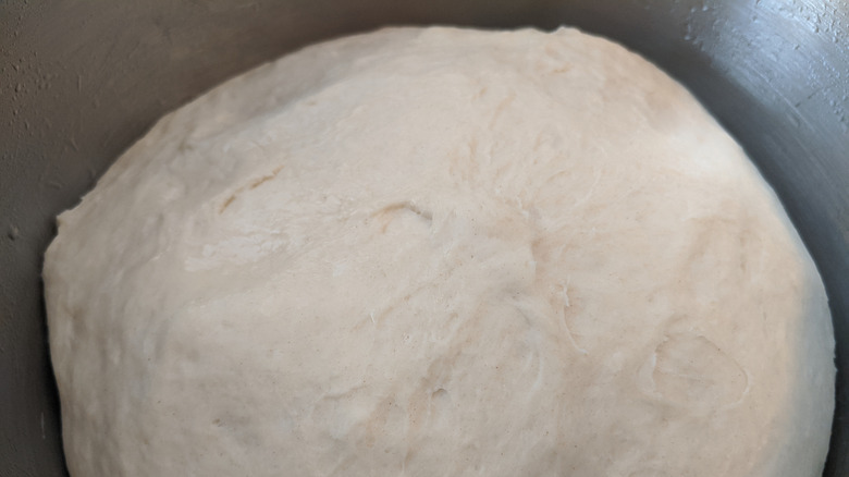 Dough rising in metal bowl