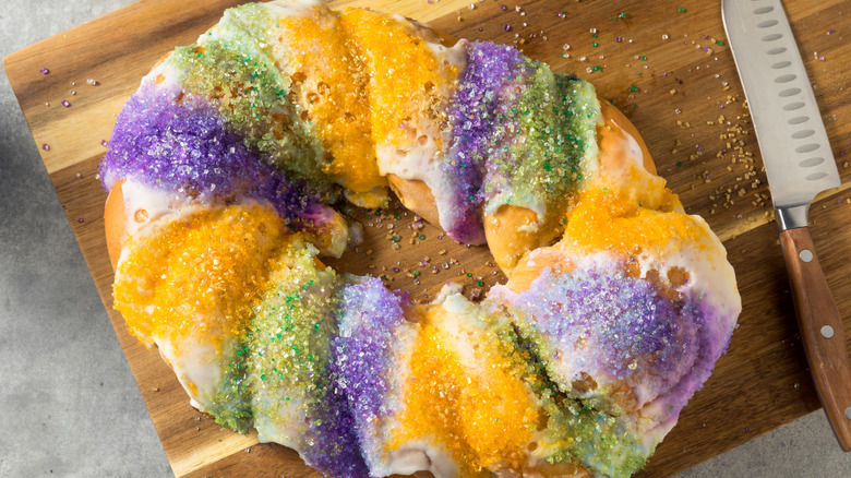 King cake on cutting board with knife