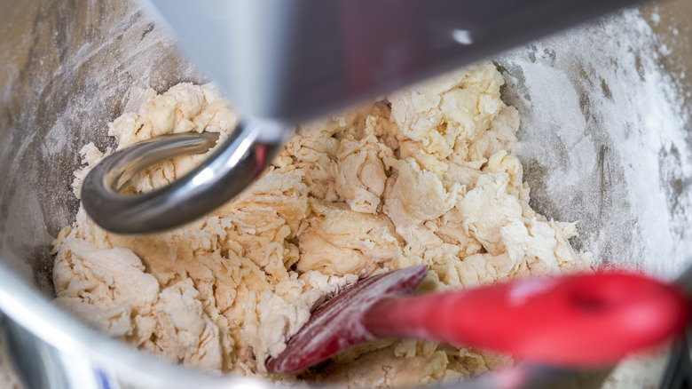 Mixing dough with dough hook and spatula in a stand mixer