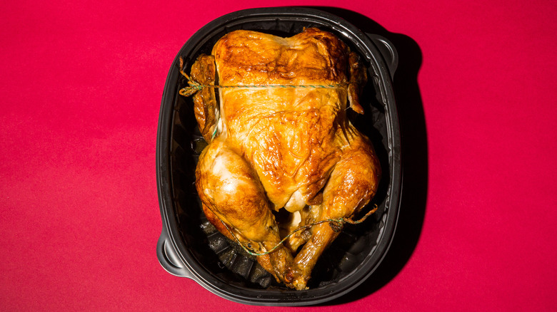 rotisserie chicken on red background