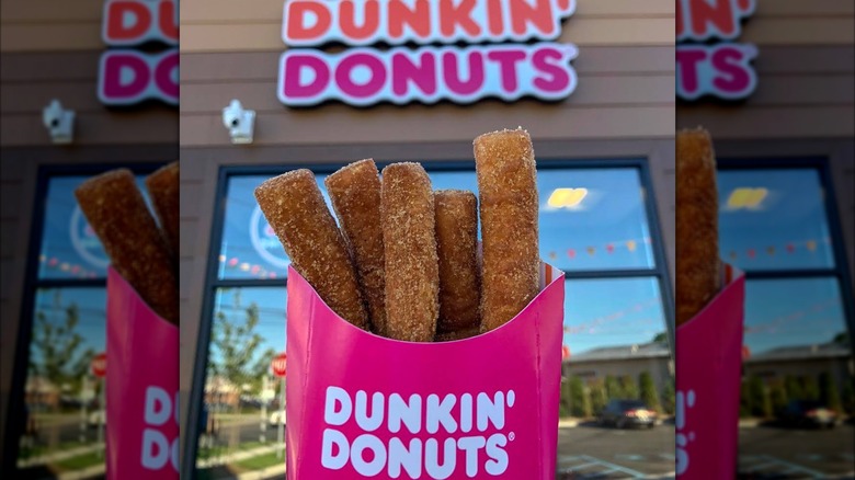 Container of Donut Fries outside in front of Dunkin' Donuts sign