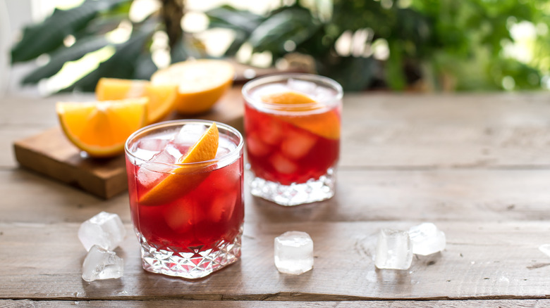 two Negronis with oranges