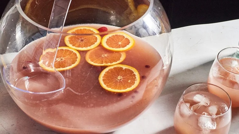 large punch bowl filled with pink jungle juice
