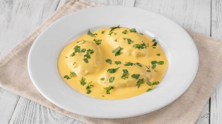 Quenelles in a bowl with sauce